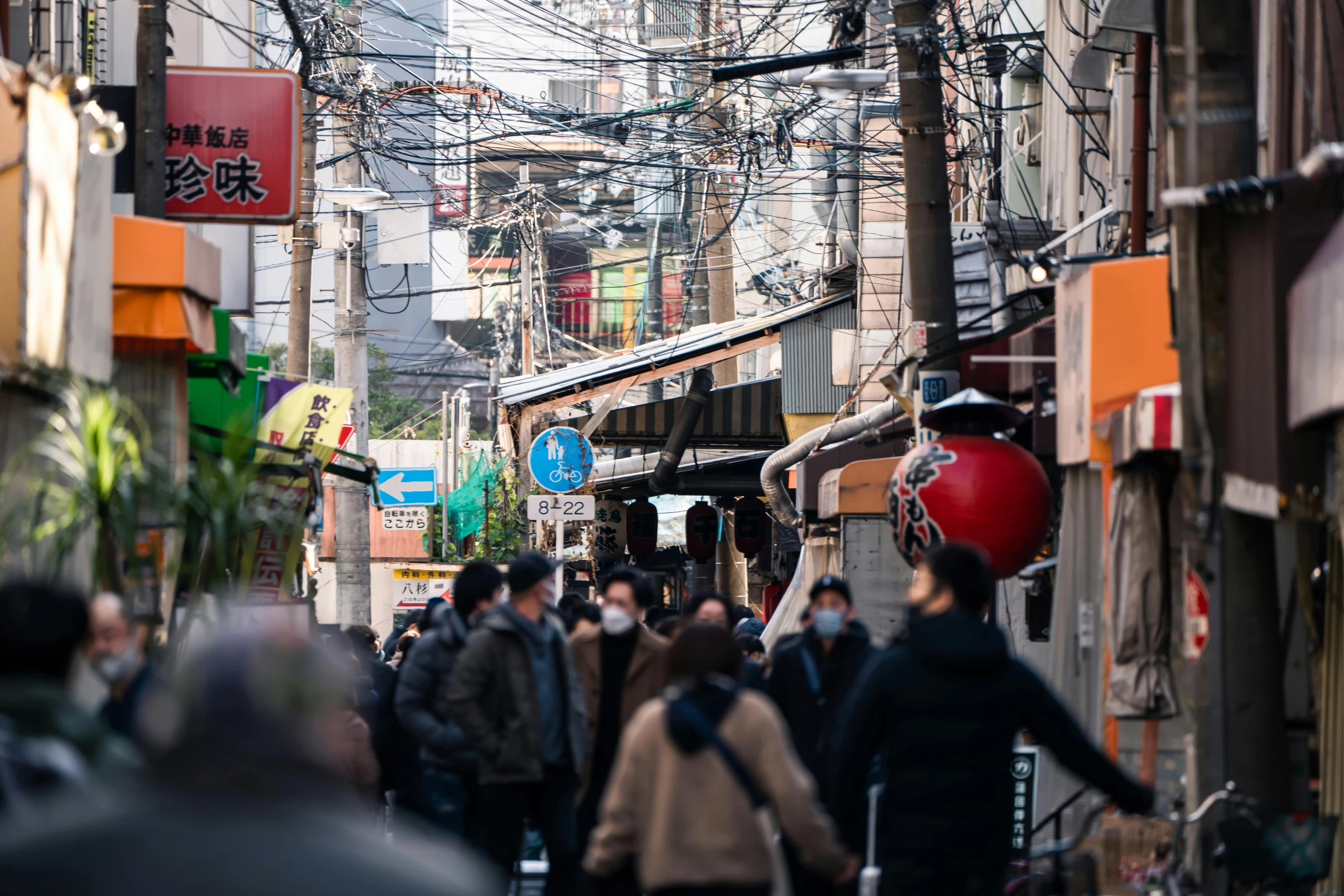 the crowded street has lots of people walking down it