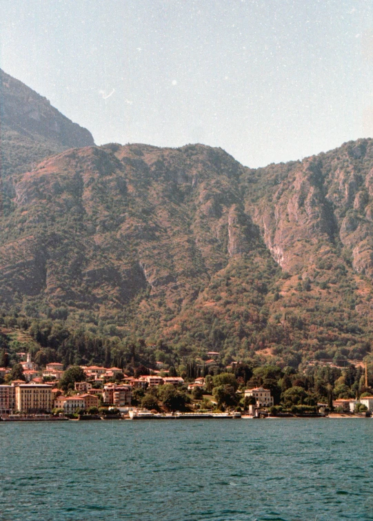 the mountains over the water and a beach area on it