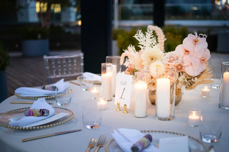 a table is set with flowers and candles on it