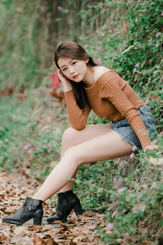 an asian woman wearing boots is posing for a po