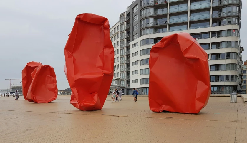 a group of red sculptures sitting next to each other