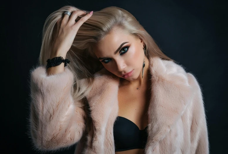 a woman with her arm on a fur jacket
