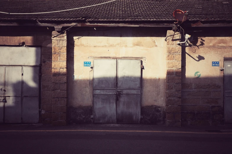 a street with some doors and windows and an object hanging off the side of it