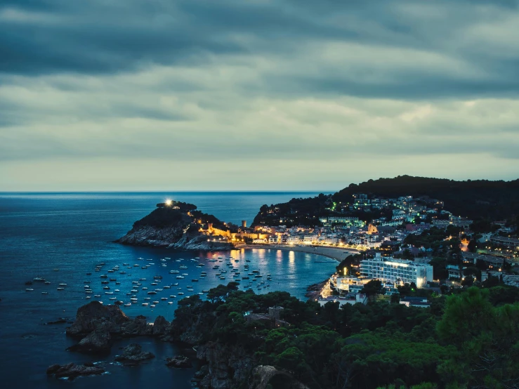 view over water at night with boats in harbor