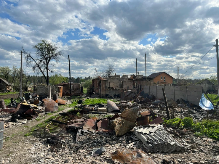 a bunch of rubble is under cloudy skies