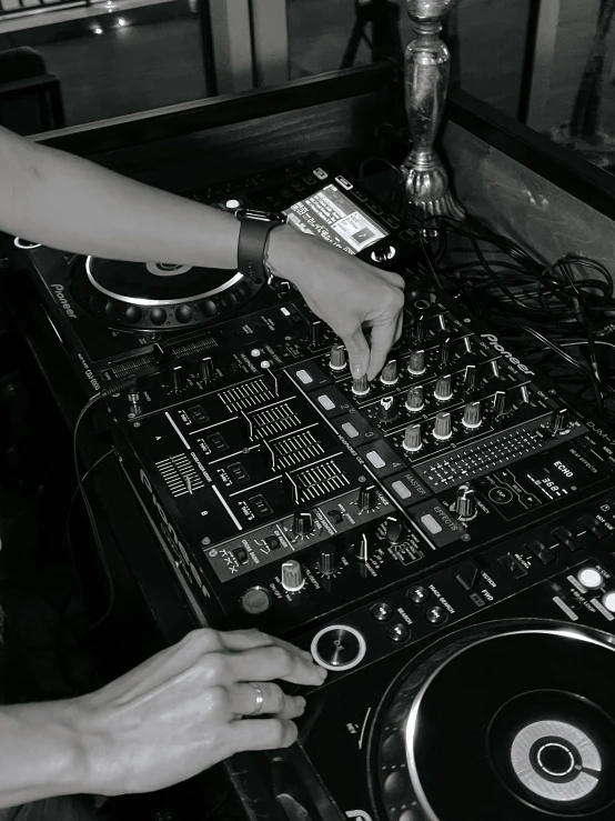 a dj mixing music in front of two decks