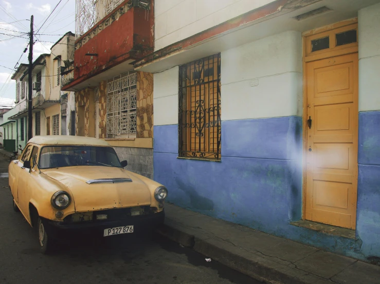 an old car parked on the side of a road