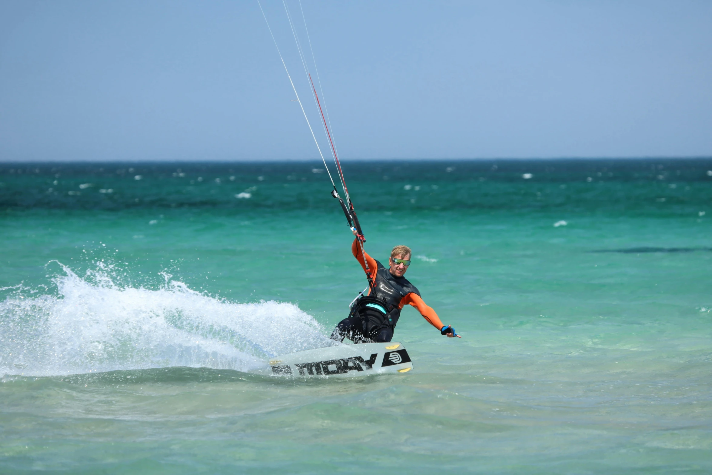 a man is riding water skis on the ocean