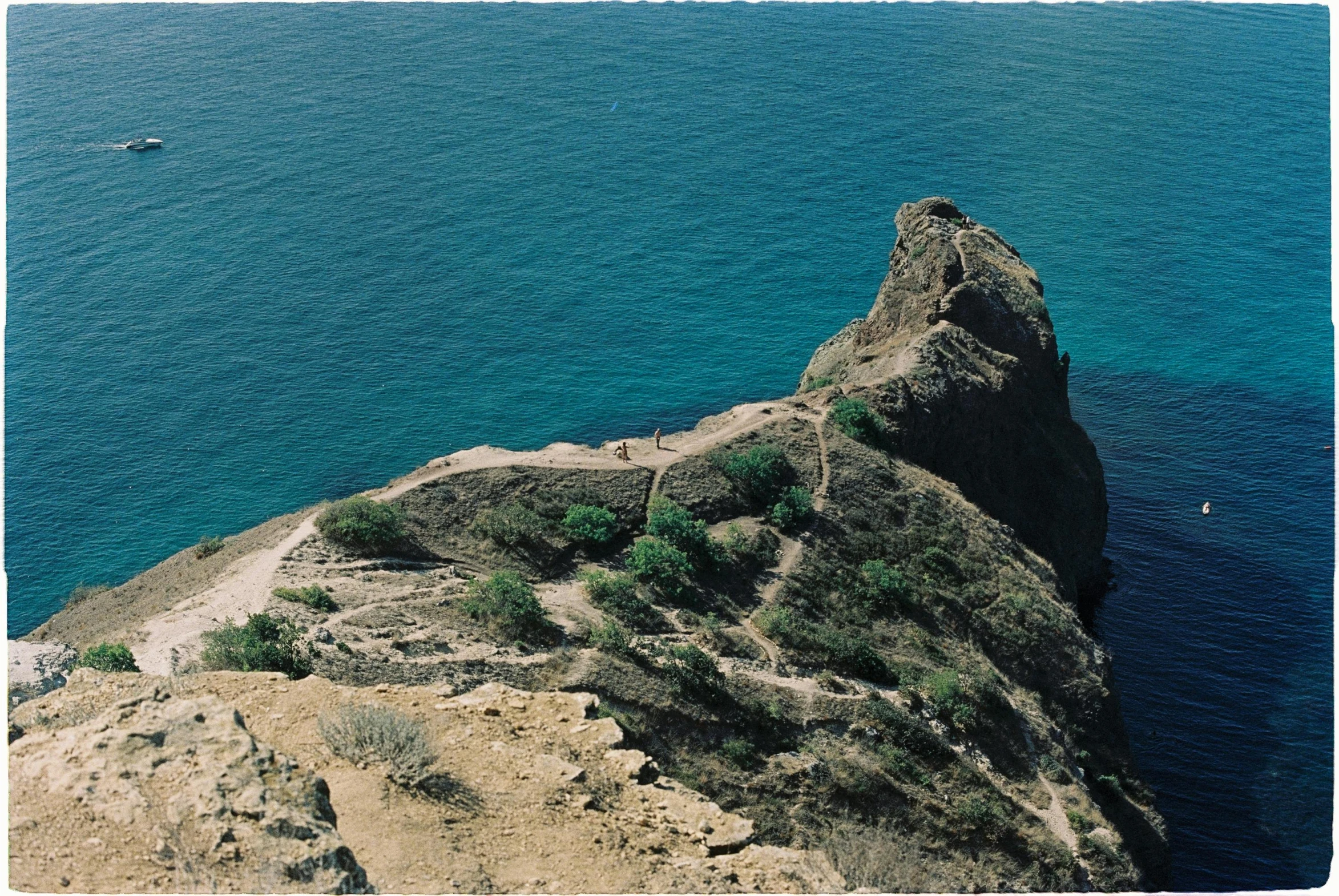 a large rock in the middle of some water