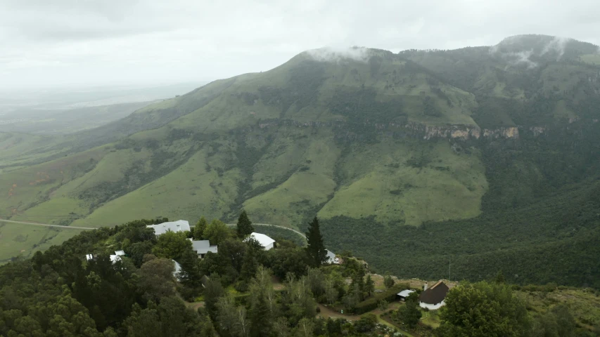 the lush green mountains with houses are shown in this view