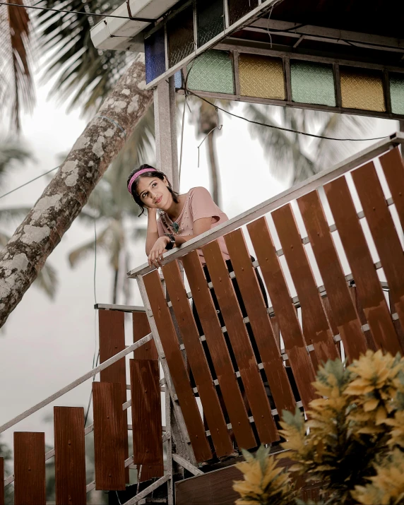 a girl standing on the stairs above the ground