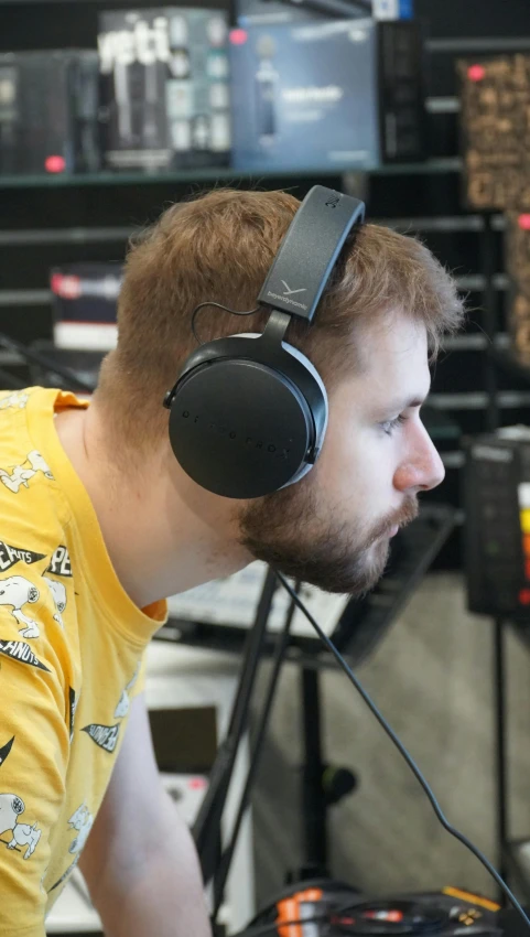 a man sitting at a desk with headphones on