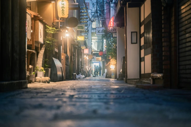 a narrow city street in the evening with buildings