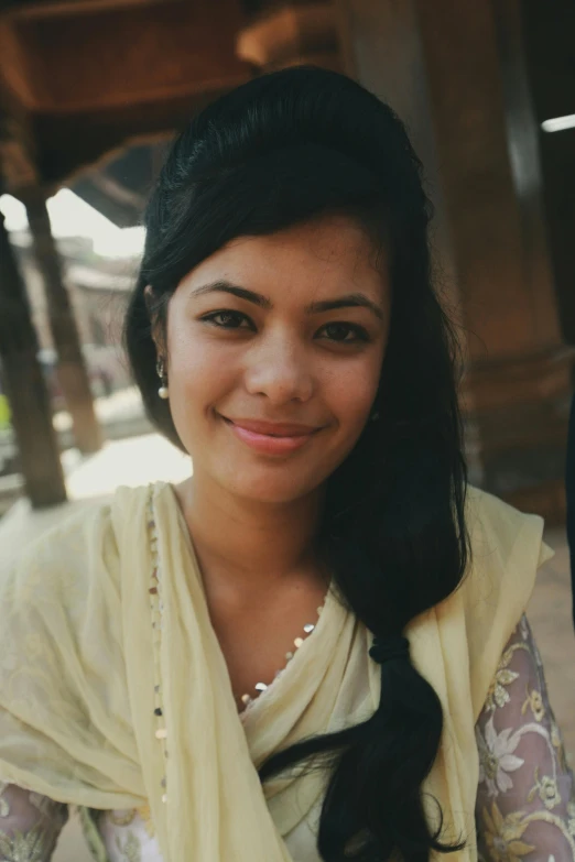 woman with long dark hair smiles into the camera