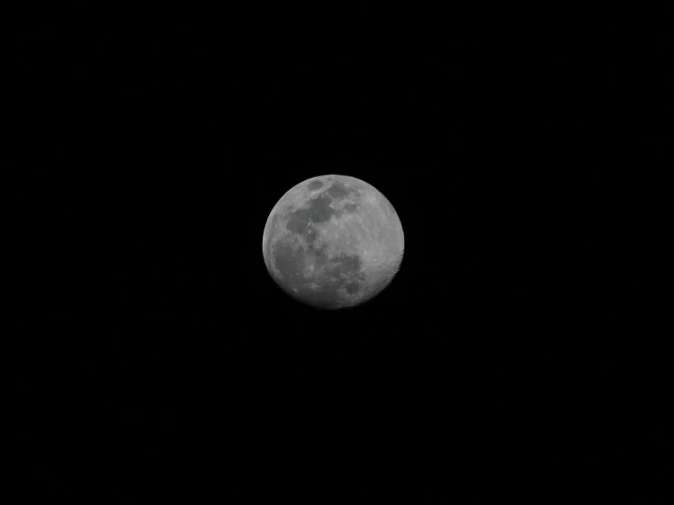 the moon taken from the sky in a black and white po