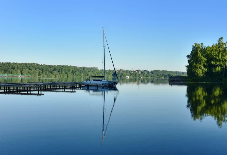 a sailboat on a lake near wooden docks