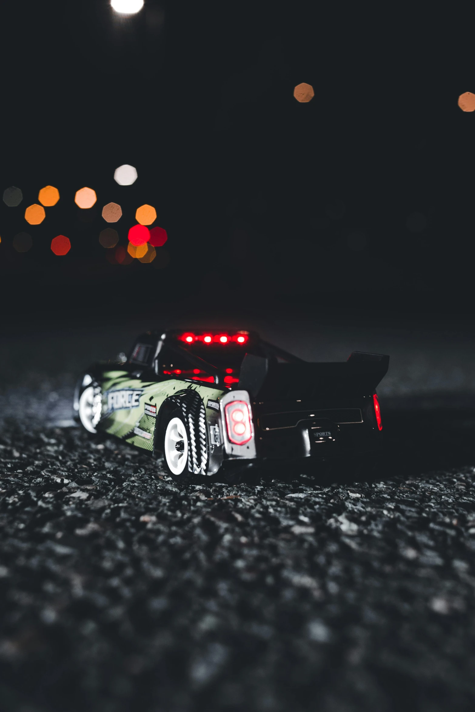 the toy car is on the gravel by himself