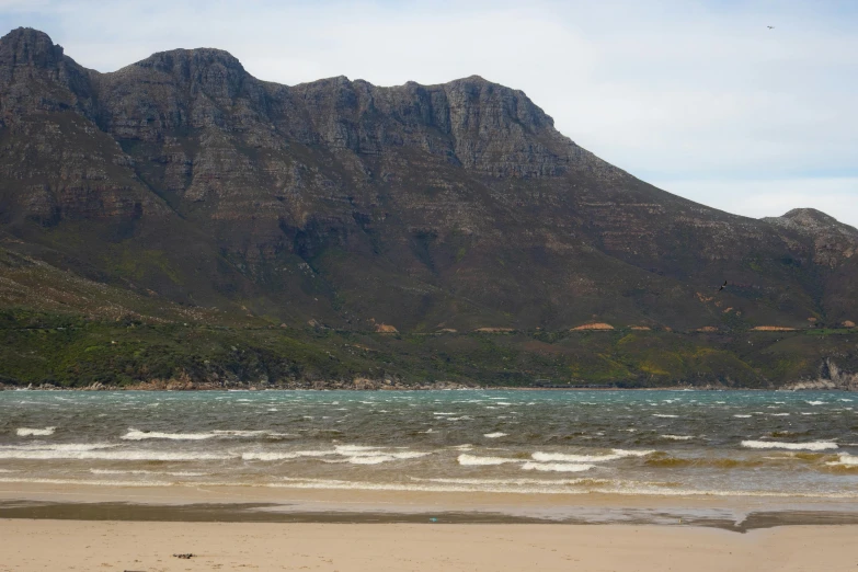 a very large mountain is near the ocean