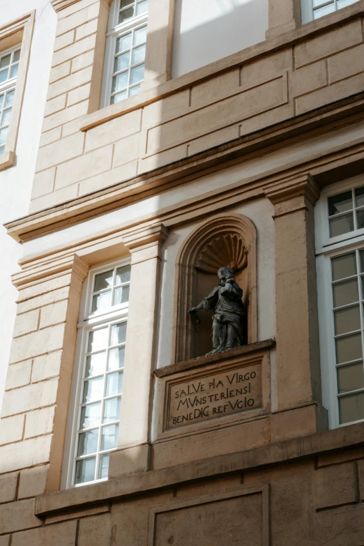 a statue sitting in the window of an old building