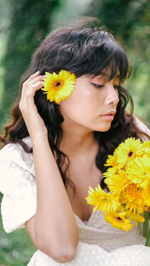 the woman with the flowers is looking off into the distance