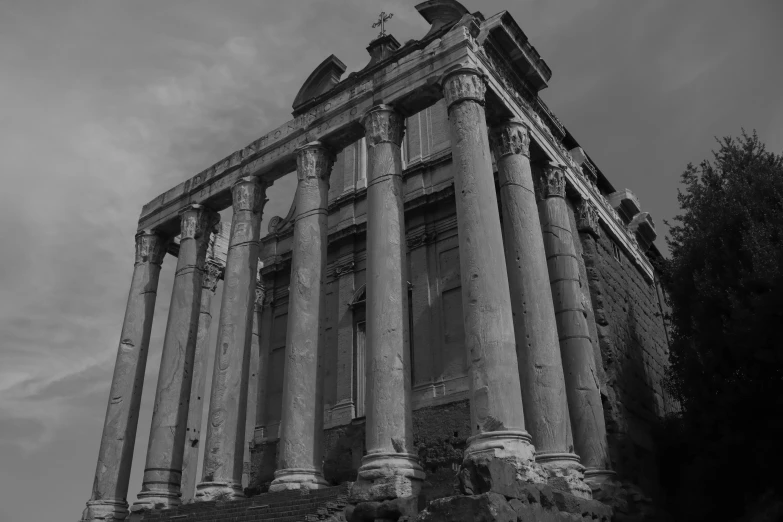 a stone building that has many columns and clocks on top of it