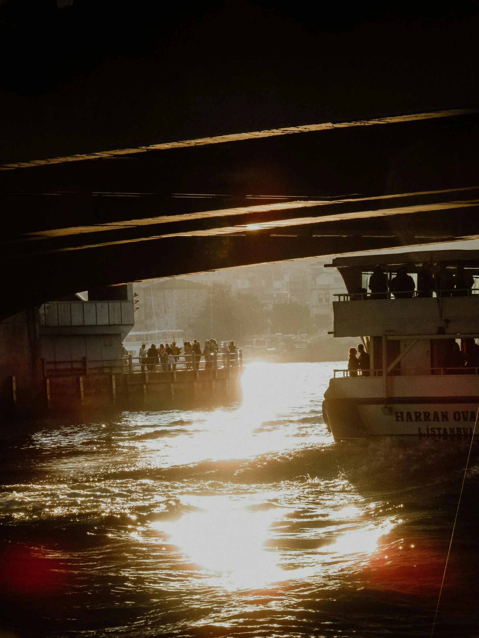 several boats floating in water under an overpass