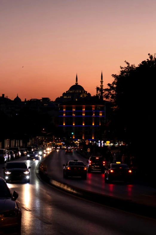 car lights shine brightly while the sun is setting