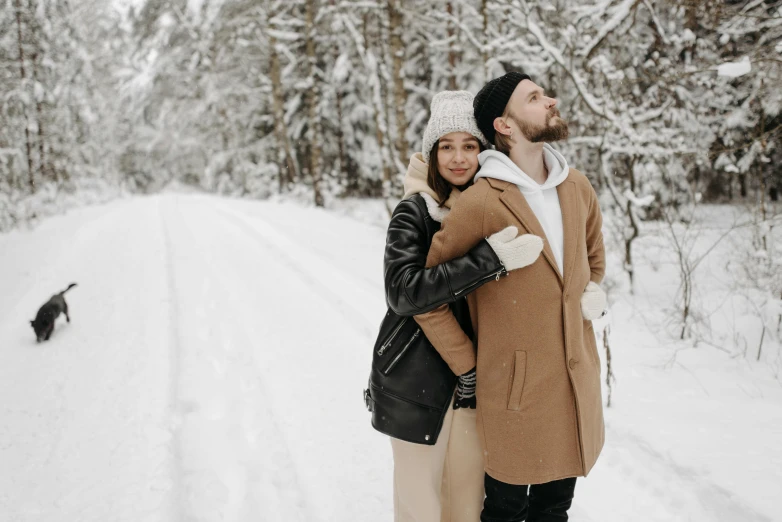 a couple posing for a picture in the snow