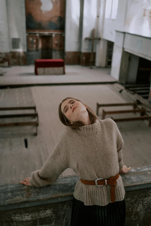 a woman standing next to the rails of an empty church