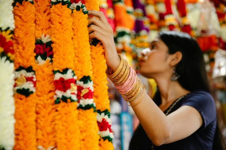 a woman smelling the top of flowers and decor