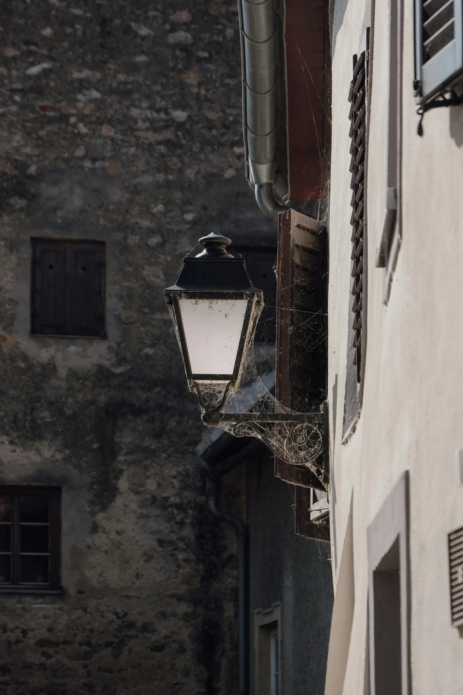 a lamp that is standing near a building