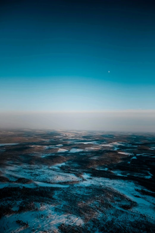 aerial view of a frozen stream below an earth surface