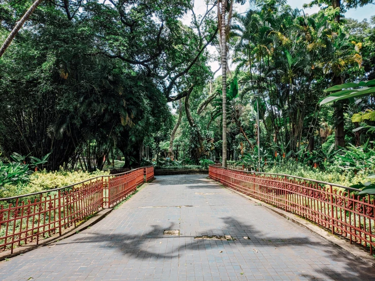 a walkway that has red metal railings on the sides