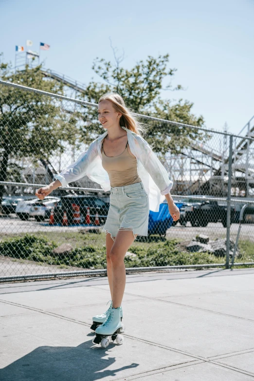 woman skateboarding on pavement at tennis court in park