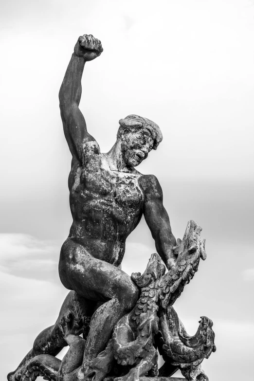 a statue made out of wood with a man in the foreground