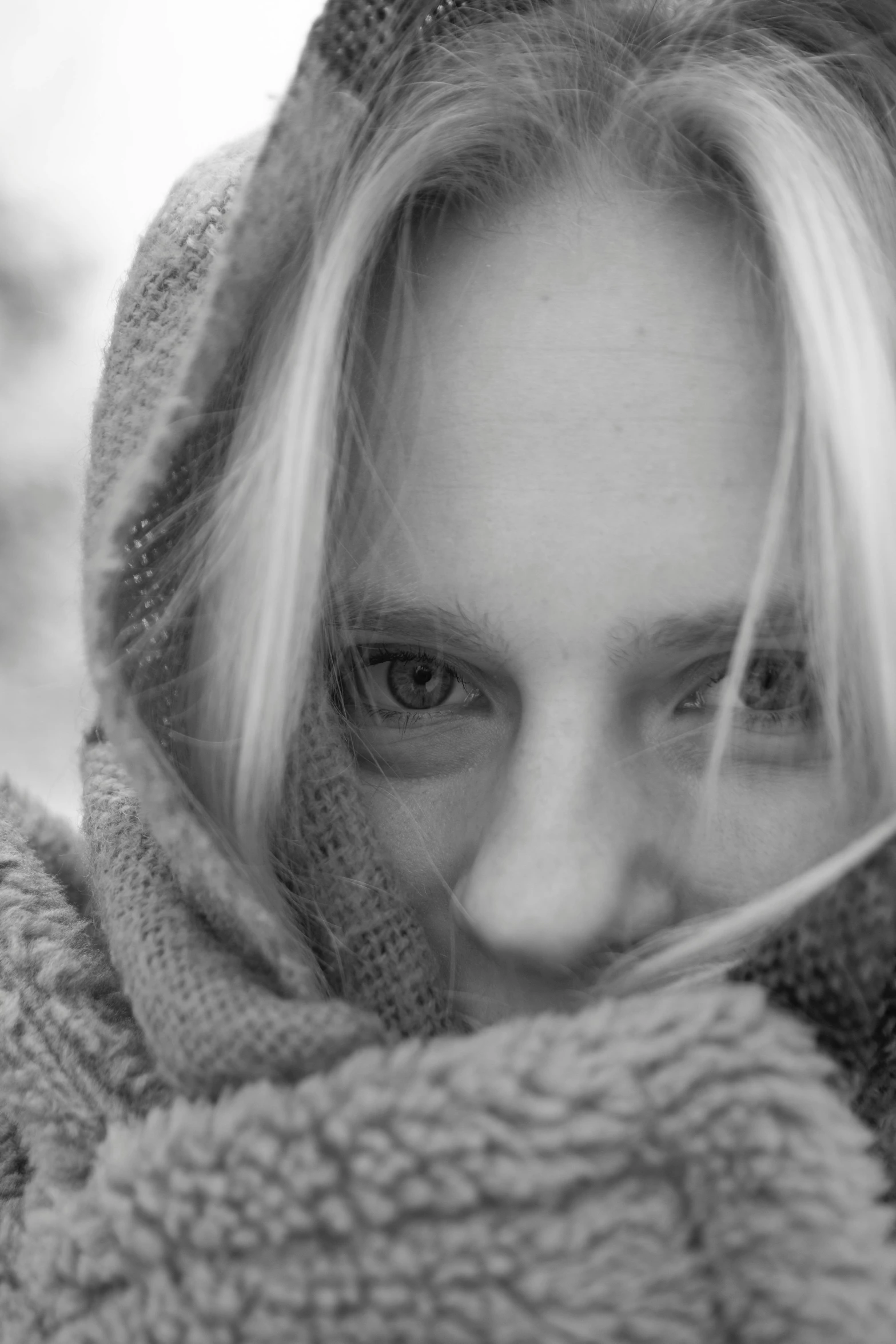 a woman with blonde hair covering her face