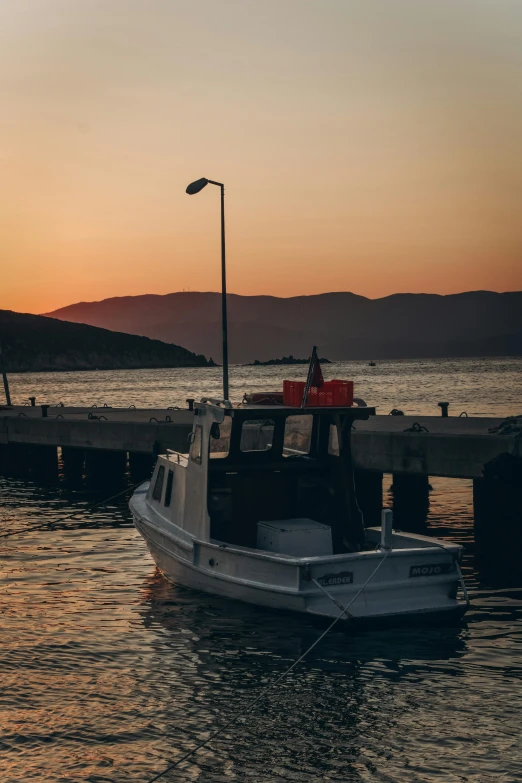 a small boat is docked near the shore