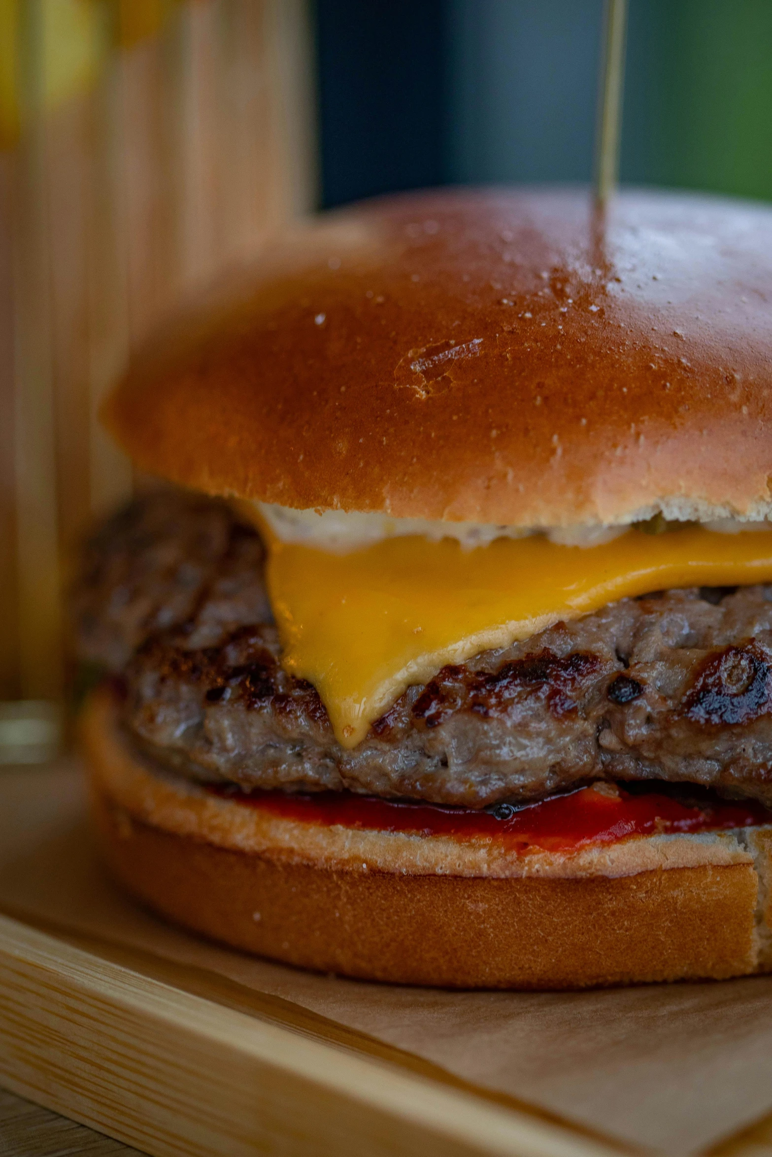 a cheeseburger with melted meat is on a table