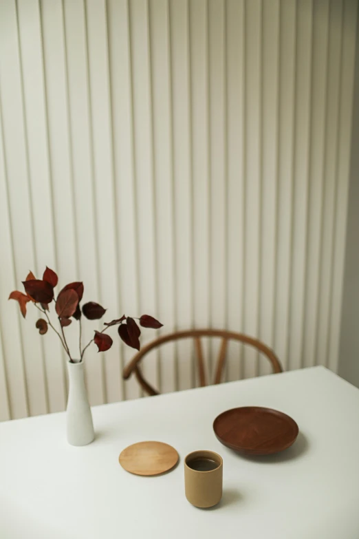 vase with three different coasters and two red and one green ones on table