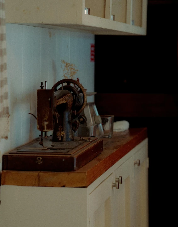 an old sewing machine in a small kitchen