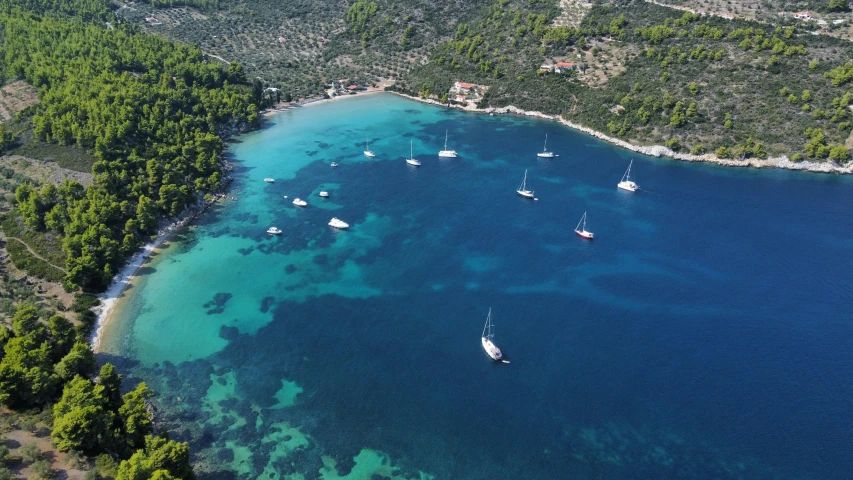 a clear blue ocean with boats in it