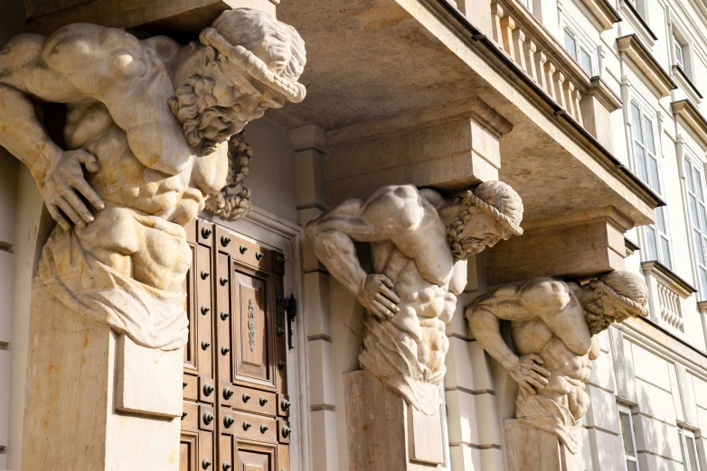 three statues of a man standing on the outside of a building