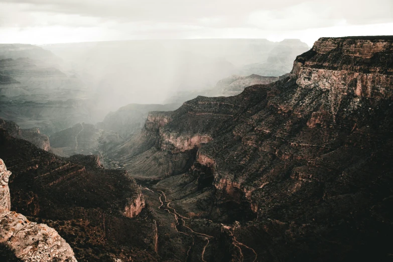 the clouds are blowing over the cliffs of the mountains