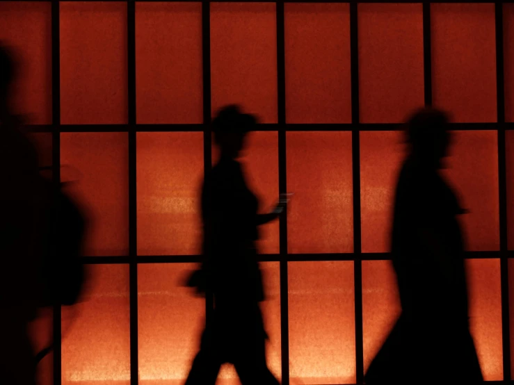 shadows of two people walking on the street