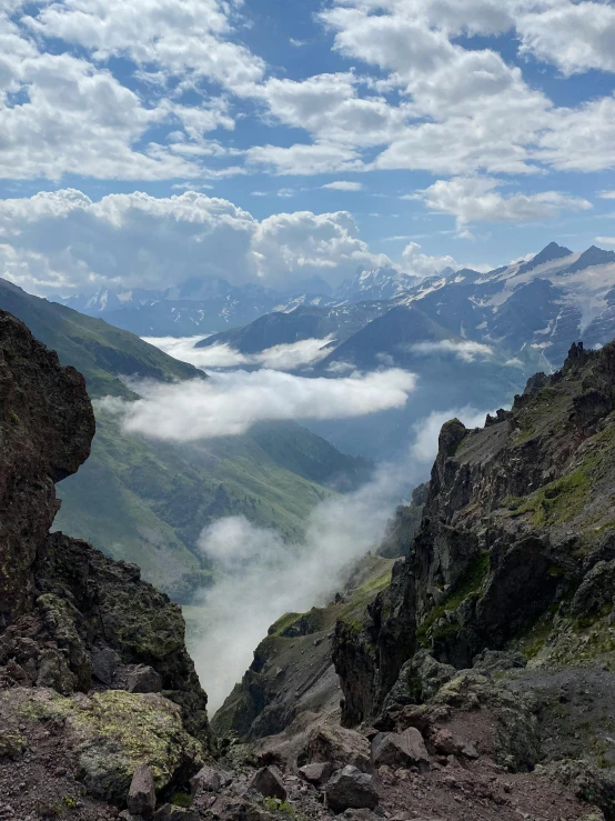 some very pretty mountains with some clouds in the sky