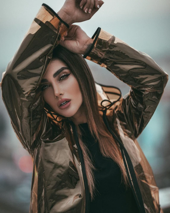 a woman wearing a rain coat poses for the camera