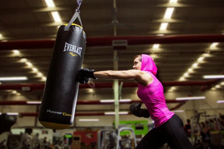 a young lady training with a punching bag