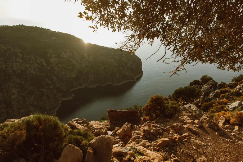 a large body of water near a green mountain