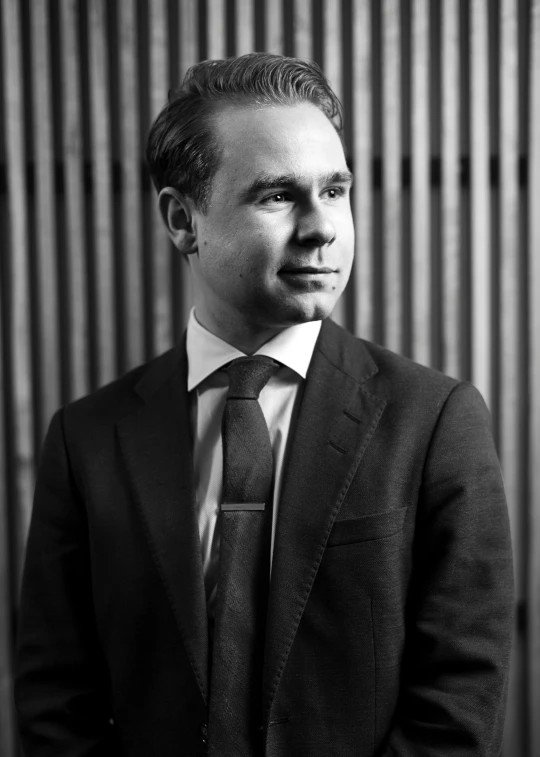 a man in a suit and tie looking away from the camera