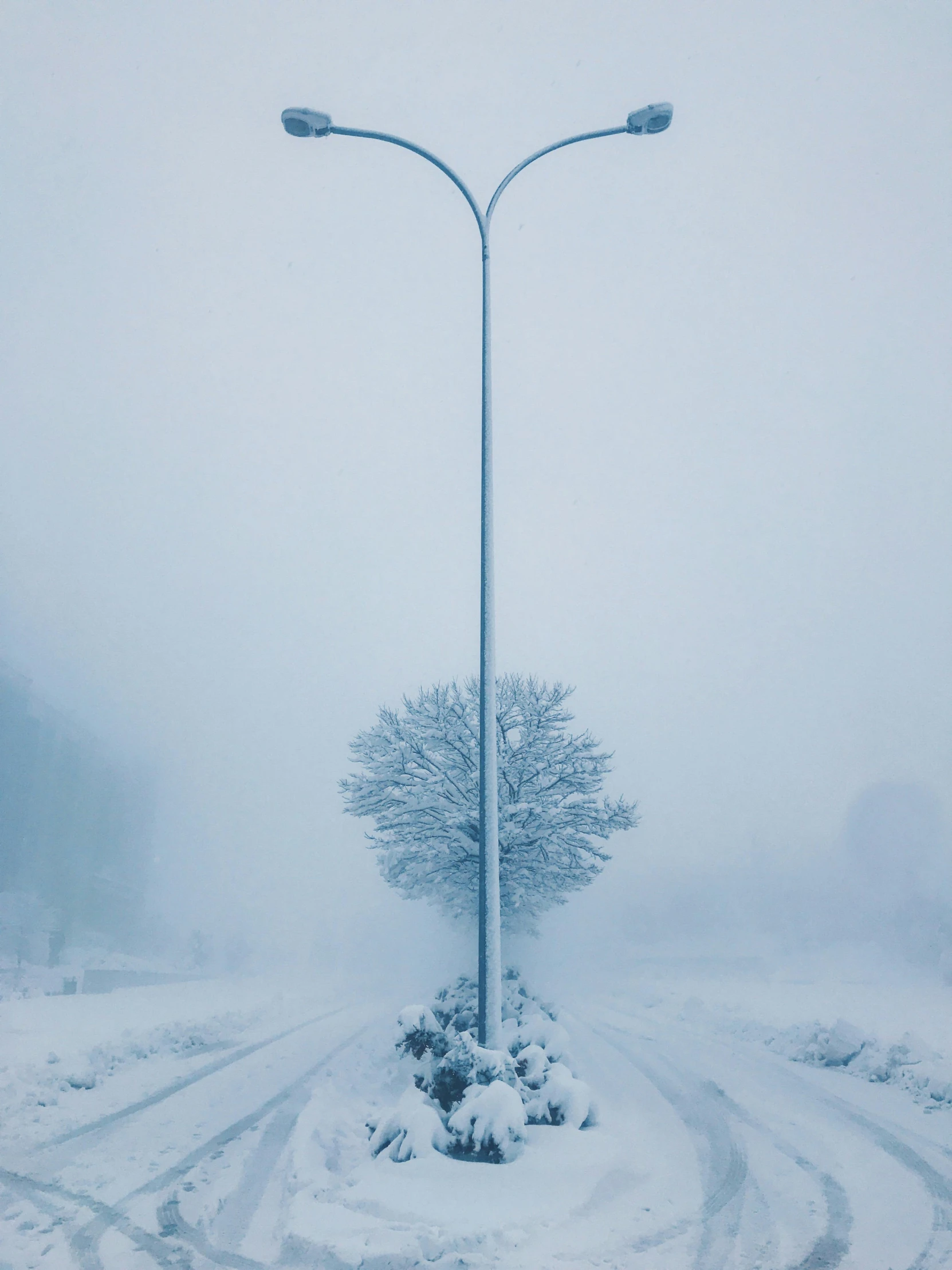 a street lamp stands amidst a snowy landscape